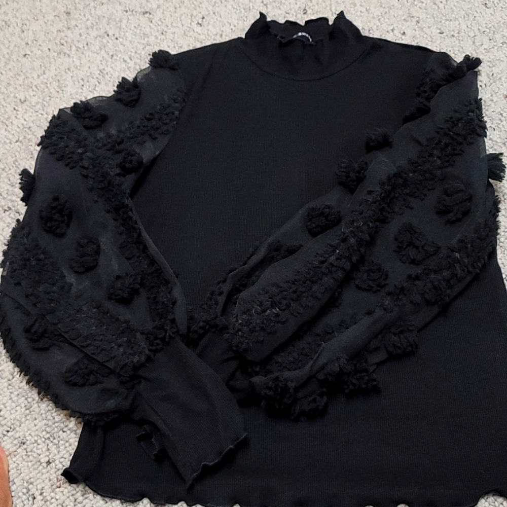 Ladies long sleeve black stretchy top!  Flowers adorn the sheer sleeves!